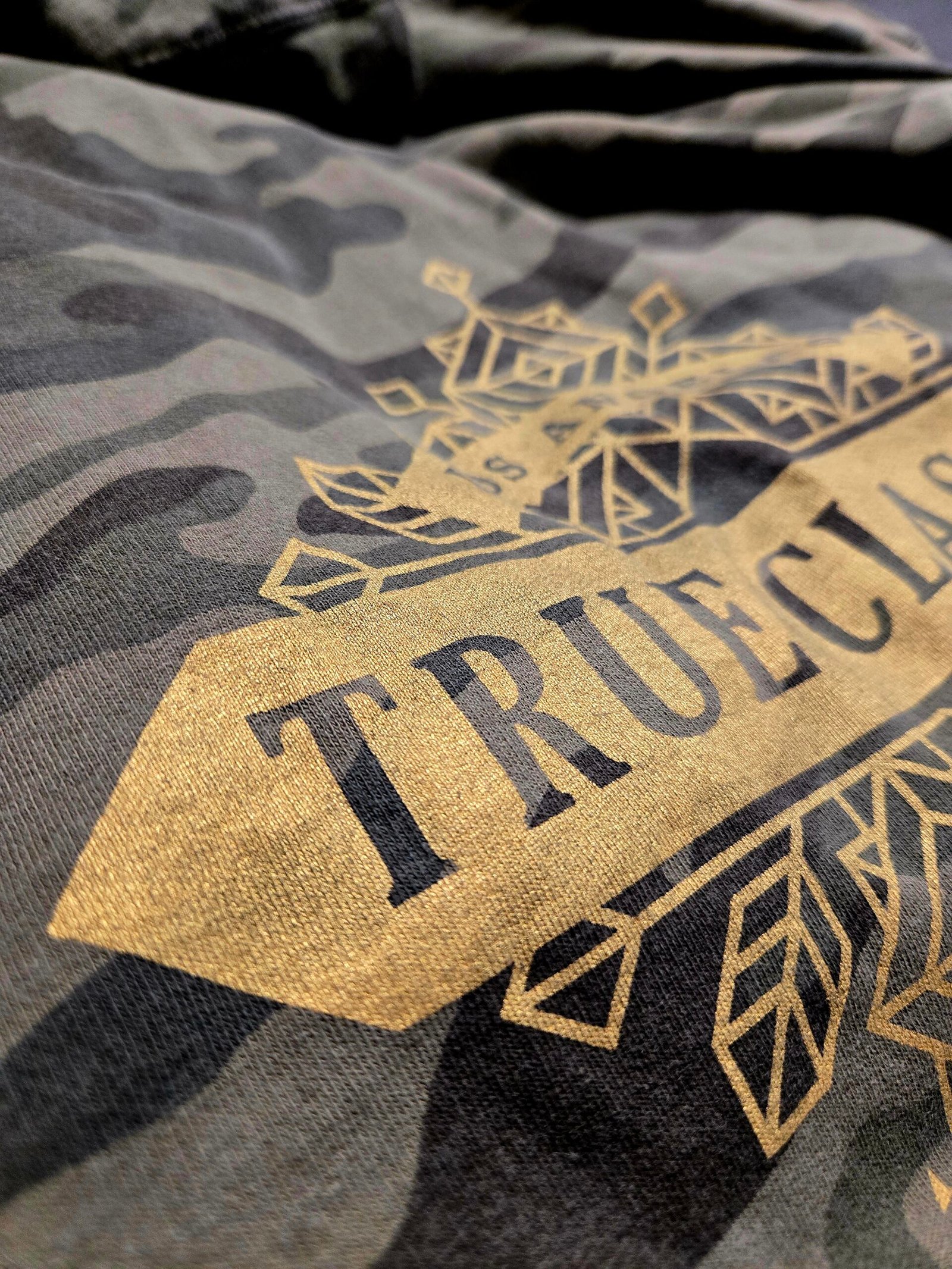 Metallic gold screen print on camouflage apparel produced by 3 Day Prints